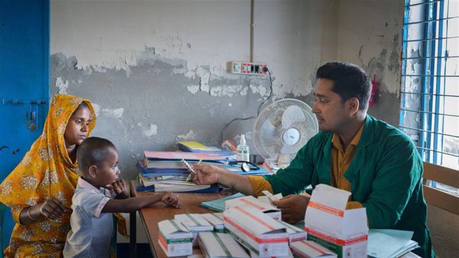A healthcare worker provides treatment for a child in an underserved community.